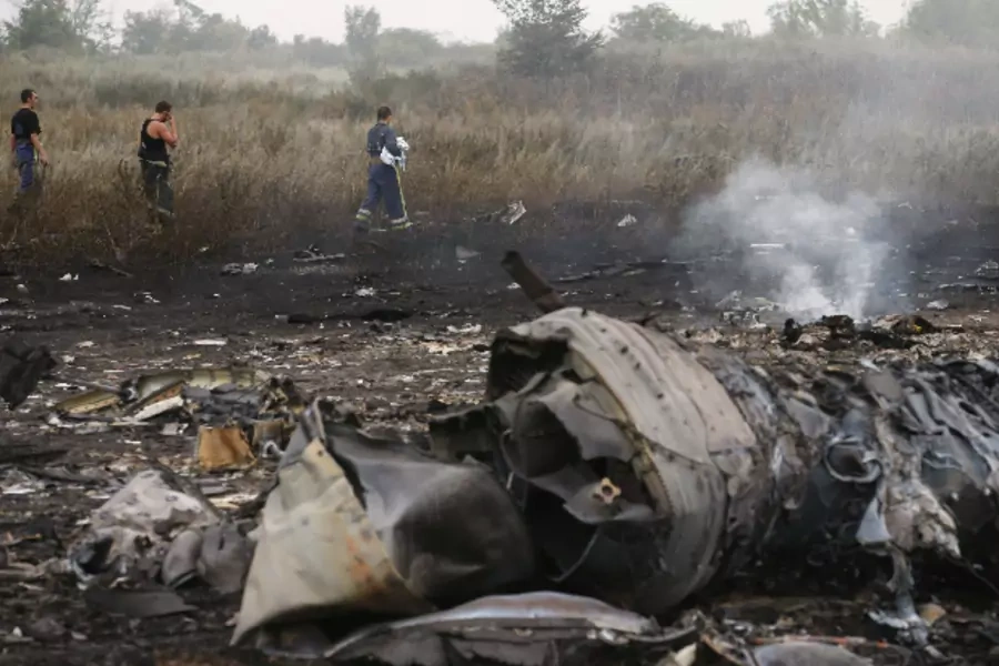 Emergencies ministry members walk at the site of a Malaysia Airlines Boeing 777 plane crash near the settlement of Grabovo in the Donetsk region on July 17, 2014 (Maxim Zmeyev/Courtesy: Reuters).