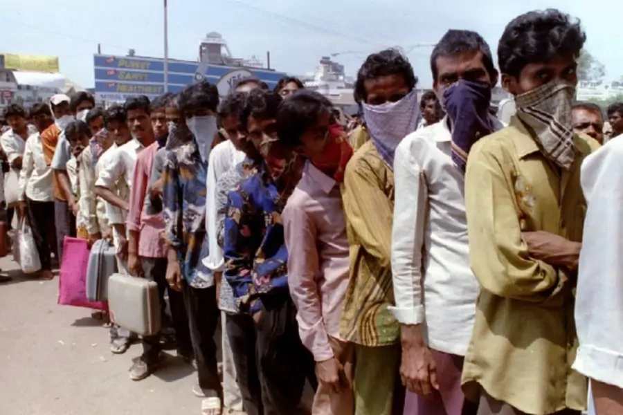 Masked residents of Surat queue up for train tickets for the first train out of the city on September 25 as the death toll due...imb. Government officials are concerned about the spread of the disease to other cities due to the exodus of people from Surat