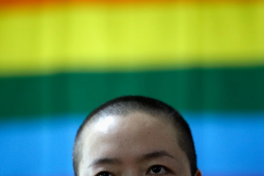 Shi tou (not her real name), a lesbian, is seen in front of a rainbow flag during a campaign to promote the acceptance of homo... also an ideal time to campaign for same-sex marriages and the acceptance of homosexuality in China. REUTERS/Jason Lee (CHINA)