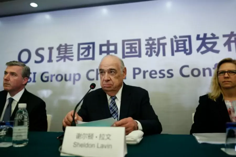 OSI Group Chairman and CEO Sheldon Lavin (C), OSI Group President and Chief Operating Officer David McDonald (L) and OSI Vice ...lion) over three years to launch a food safety education programme in Shanghai. REUTERS/Aly Song (CHINA - Tags: BUSINESS FOOD)