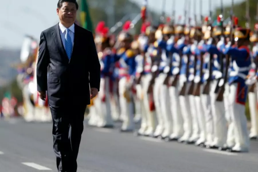 China's President Xi Jinping reviews an honor guard before a meeting with Brazilian President Dilma Rousseff on the sidelines ...he 6th BRICS summit at the Planalto Palace in Brasilia July 17, 2014. REUTERS/Sergio Moraes (BRAZIL - Tags: POLITICS MILITARY)