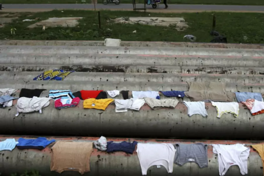 Local residents' clothes dry over the gas pipelines running through the Eleme community near the city of Port Harcourt, a major Nigerian oil hub in the country's southeast.