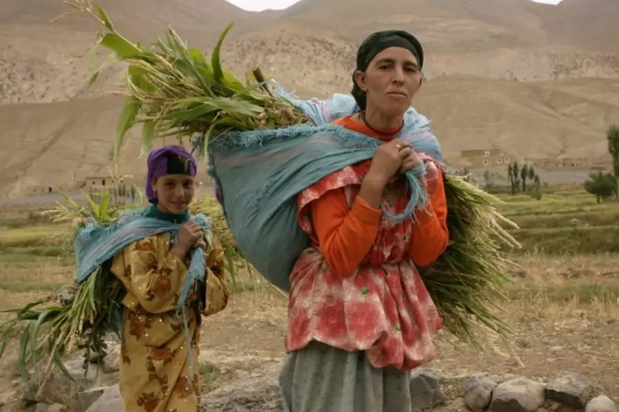 Women carry silage on their backs in the High Atlas, Morocco, August 2006 (Courtesy Reuters/Eve Coulon).
