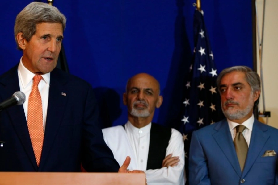 U.S. Secretary of State John Kerry speaks next to Afghan presidential candidates Ashraf Ghani Ahmadzai and Abdullah Abdullah in Kabul, Afghanistan, following the signing of a deal to form a national unity government (Courtesy Reuters/Omar Sobhani).