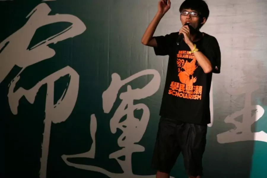 Joshua Wong, a 17-year-old who heads the group leading a pupils' protest, Scholarism, addresses a rally in Hong Kong September...esign. The Chinese characters on the background read "Fate". REUTERS/Bobby Yip (CHINA - Tags: POLITICS EDUCATION CIVIL UNREST)