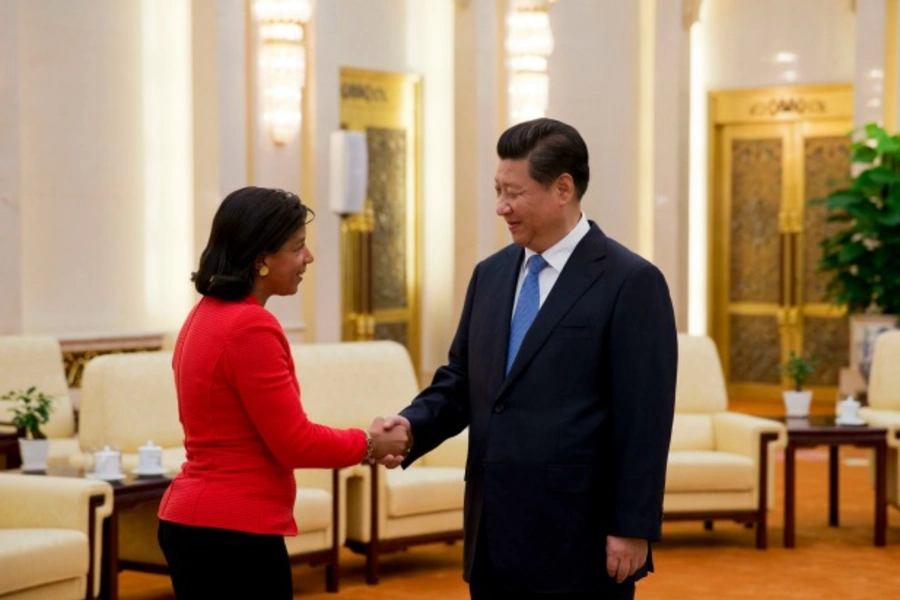 U.S. National Security Advisor Susan Rice (L), shakes hands with Chinese President Xi Jinping during a meeting at the Great Hall of the People, in Beijing September 9, 2014. REUTERS/Andy Wong/Pool (CHINA - Tags: POLITICS MILITARY)