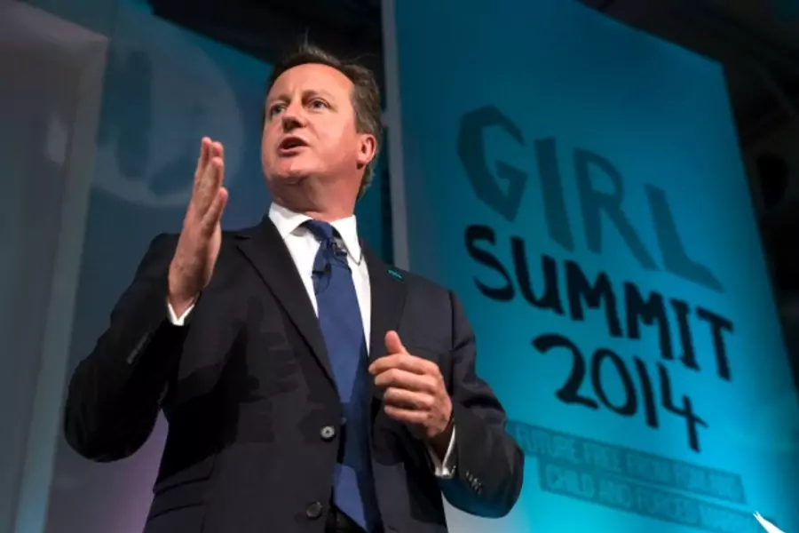 Britain's Prime Minister David Cameron speaks at the Girl Summit in London, July 22, 2014. The prime minister announced that B...it compulsory for teachers and health workers to report cases of female genital mutilation (Courtesy Reuters/Oli Scarff/Pool).