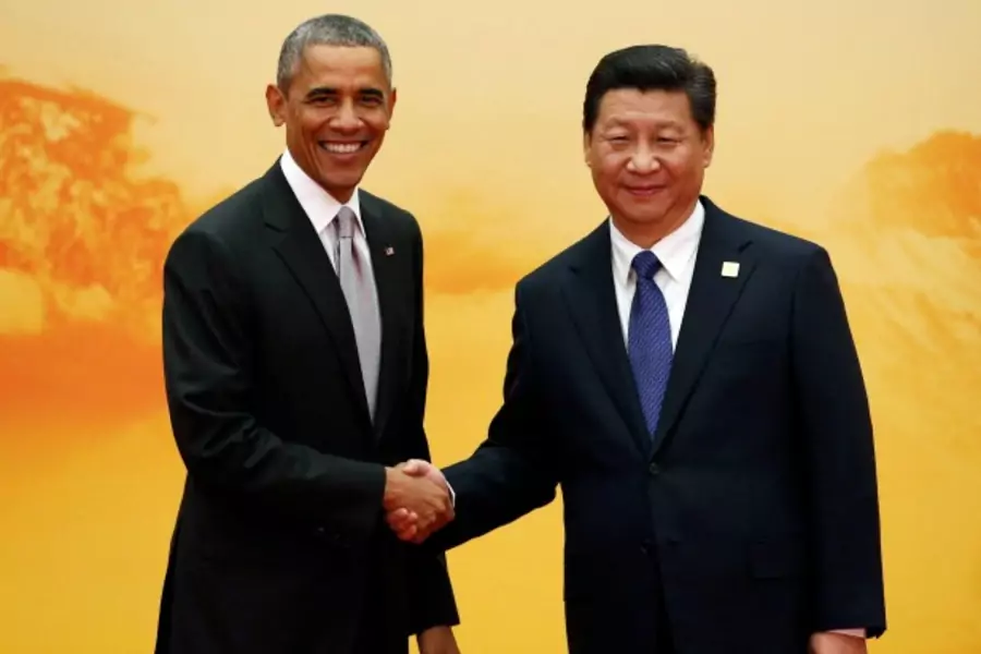 U.S. President Barack Obama (L) shakes hands with China's President Xi Jinping during the Asia Pacific Economic Cooperation (A...ational Convention Center at Yanqi Lake in Beijing November 11, 2014. REUTERS/Kim Kyung-Hoon (CHINA - Tags: BUSINESS POLITICS)