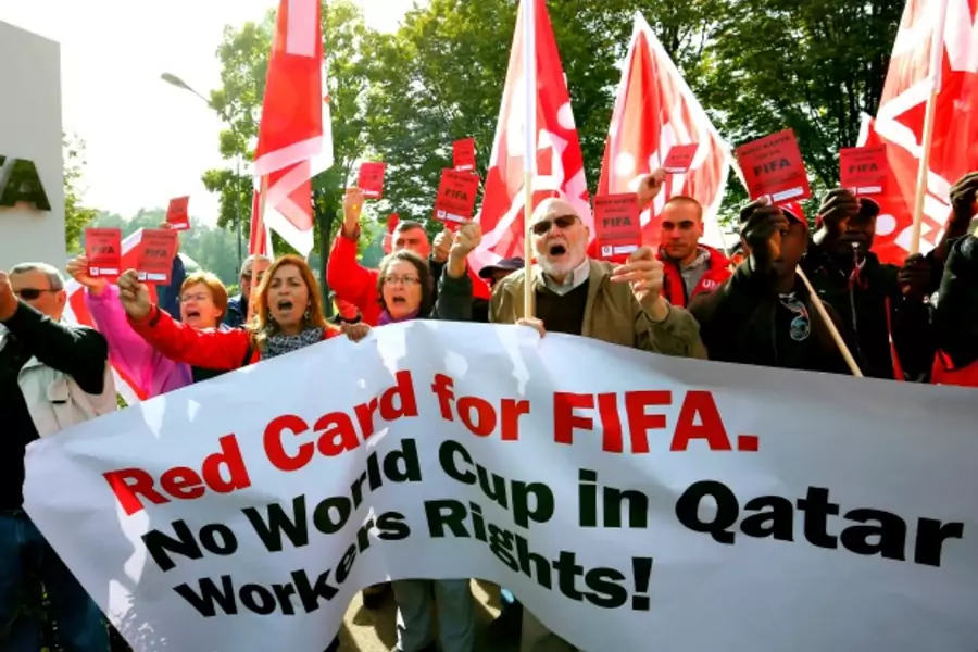 Members of the Swiss UNIA workers union protest the Qatar 2022 World Cup in front of the headquarters of soccer's international governing body FIFA in Zurich, Switzerland, October 2013 (Courtesy Reuters/Arnd Wiegmann).