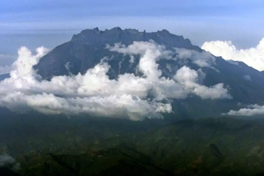 Mount Kinabalu appears through the clouds over Kota Kinabalu, capital of the east Malaysian state of Sabah on Borneo island, i...u is Southeast Asia's highest mountain, standing at 4,095 metres (13,432 feet). Picture taken March 8. REUTERS/Bazuki Muhammad