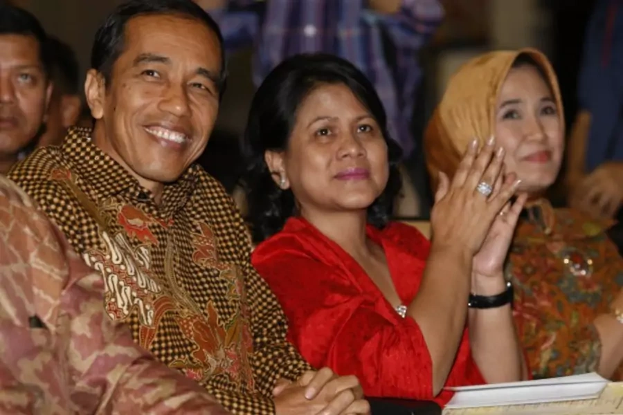 Indonesian President Joko Jokowi Widodo and his wife Iriana react as names are read out during their son's graduation ceremony...emony of his youngest son, Kaesang Pangarep, according to local media. REUTERS/Edgar Su (SINGAPORE - Tags: EDUCATION POLITICS)