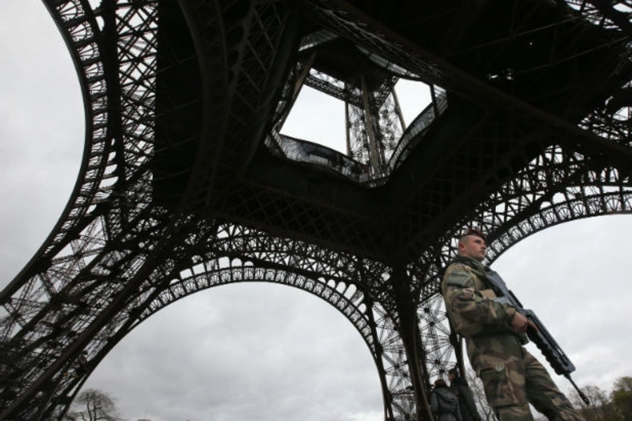 An armed French soldier stands beneath the Eiffel Tower days after the terrorist attacks against the offices of the Charlie Hebdo magazine and a kosher supermarket in Paris, France.