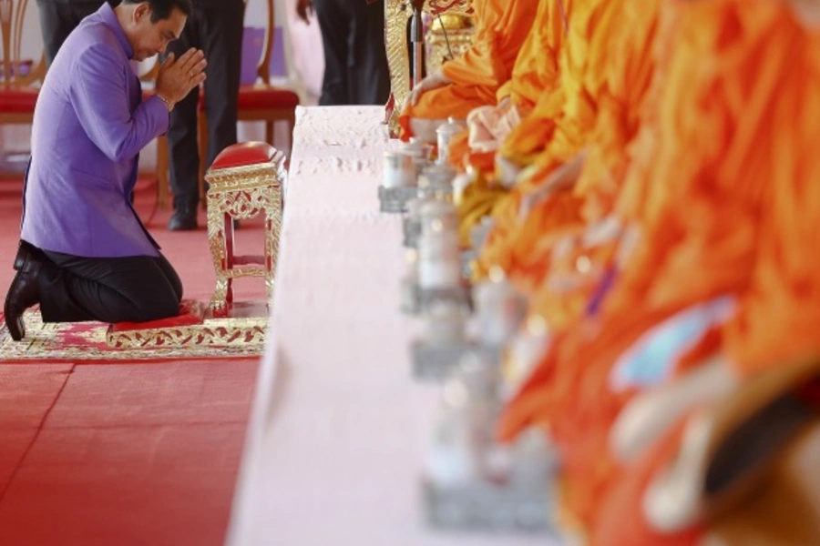 Thailand's Prime Minister Prayuth Chan-ocha prays as he takes a part in the merit-making ceremony on the occasion of Princess Maha Chakri Sirindhorn's birthday at Sanam Luang in Bangkok on April 2, 2015. (Damir Sagolj/Courtesy: Reuters)