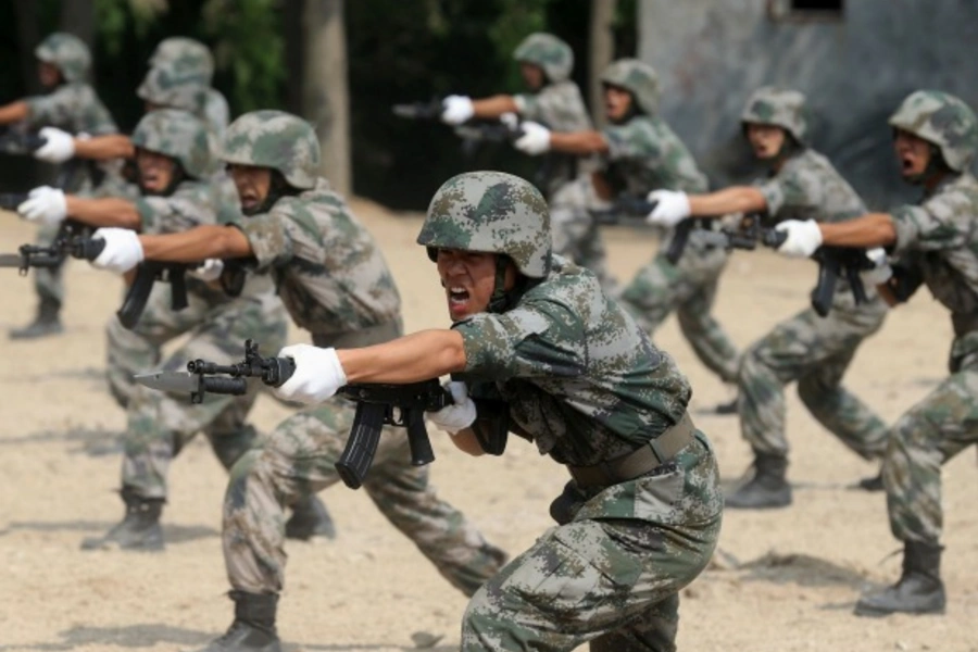 Members of People's Liberation Army (PLA) coastal defence force shout as they practise during a drill to mark the upcoming 87t... 29, 2014. REUTERS/Stringer (CHINA - Tags: MILITARY POLITICS ANNIVERSARY) CHINA OUT. NO COMMERCIAL OR EDITORIAL SALES IN CHINA