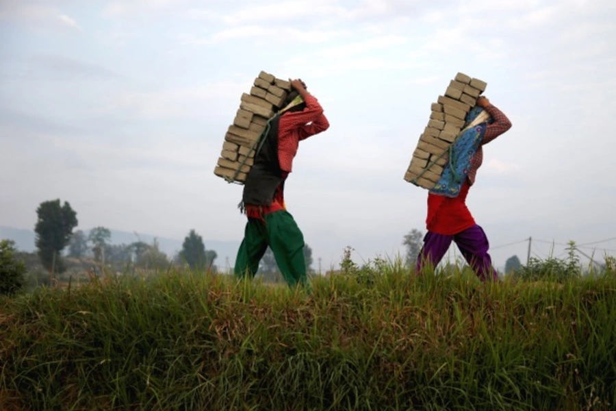 Women carry bricks on their back as they work at a brick factory in Bhaktapur, Nepal. (Courtesy Ahmad Masood/Reuters)