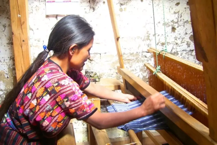 An entrepreneur in Guatemala works on her loom. She received support from Friendship Bridge, a client of MCE Social Capital that provides impoverished Guatemalan women microfinance and education services, 2013. (Courtesy Friendship Bridge)