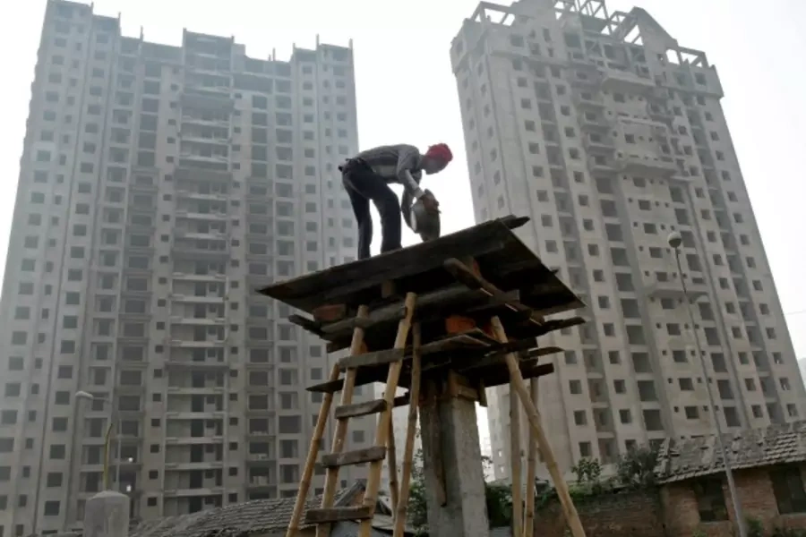 A labourer works at the construction site of a residential complex in Kolkata, December 21, 2013 (Rupak De Chowdhuri/Reuters).