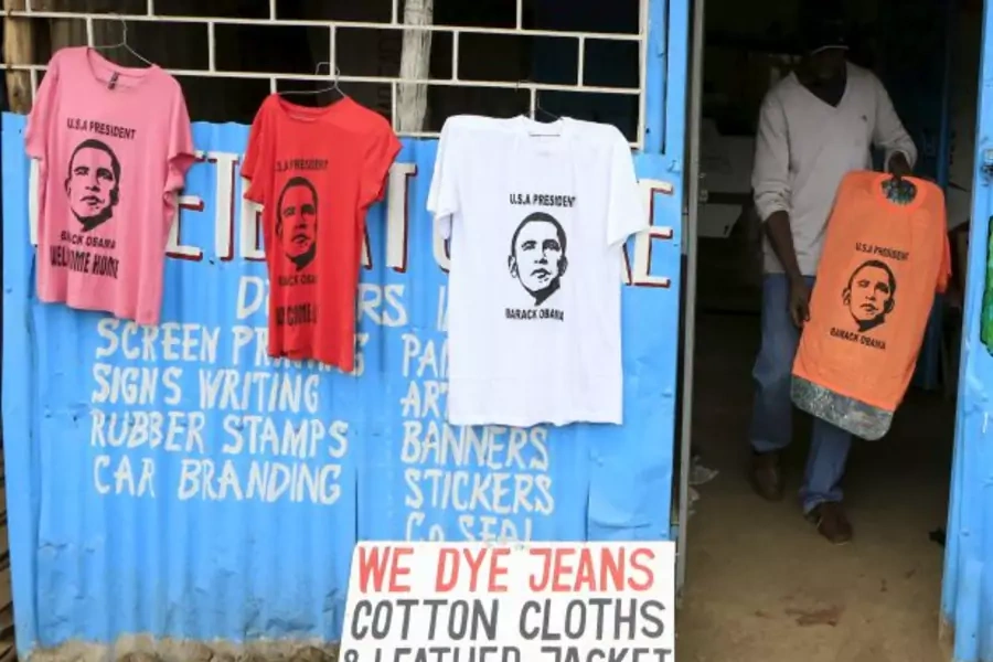 Wycliff Madegwa prepares to display a t-shirt newly printed with the image of U.S. President Barack Obama, ahead of his schedu...ection to his father's birthplace will dominate a trip that Kenyans view as a native son returning home (Noor Khamis/Reuters).