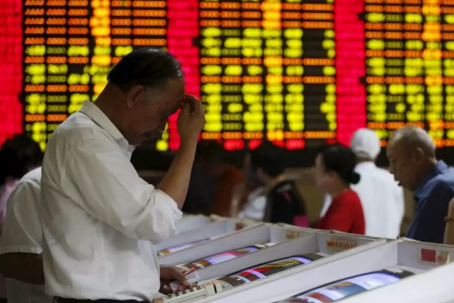 Investors look at computer screens showing stock information at a brokerage house in Shanghai, China, July 8, 2015. Chinese st...economy was in the grip of "panic sentiment" as investors ignored a battery of support measures from Beijing. REUTERS/Aly Song
