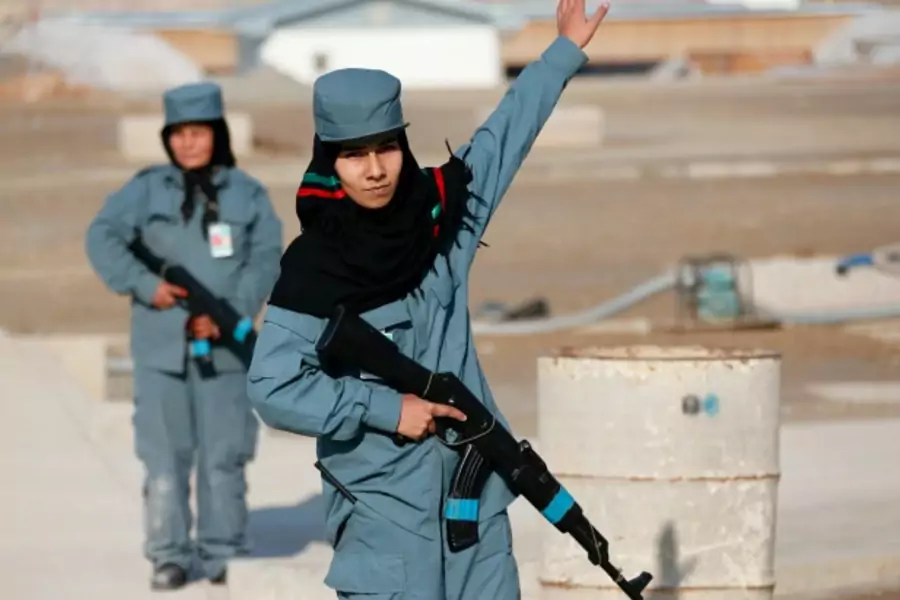 A female Afghan National Police (ANP) officer gives instructions during a patrol training session, at a training center near the German Bundeswehr army camp in Kunduz, northern Afghanistan, December 2012 (Courtesy Fabrizio Bensch/Reuters).