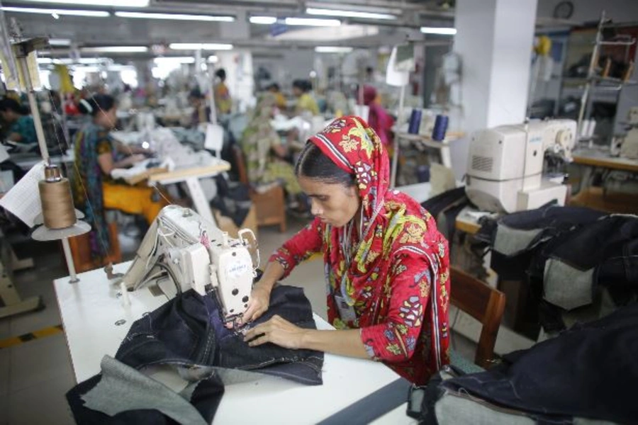 A worker works in a factory of Ananta Garments Ltd in Savar June 10, 2014. Picture taken June 10, 2014. To match Insight Bangladesh-Textiles (Reuters/Andrew Biraj)