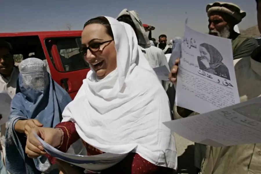 Shukria Barakzai, a member of parliament, hands out leaflets during her August 2005 election campaign in Kabul, Afghanistan. Barakzai later survived a suicide bombing attack in December 2014 (Courtesy Zohra Bensemra/Reuters).