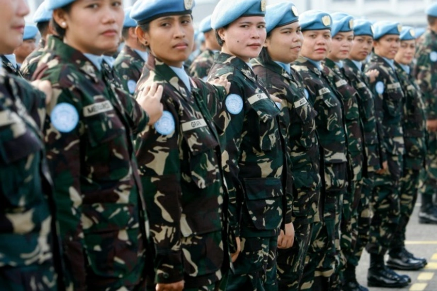 Female members of a Philippine peacekeeping force bound for Liberia stand at attention during a send-off ceremony at the military headquarters in Manila, January 2009 (Romeo Ranoco/Reuters).