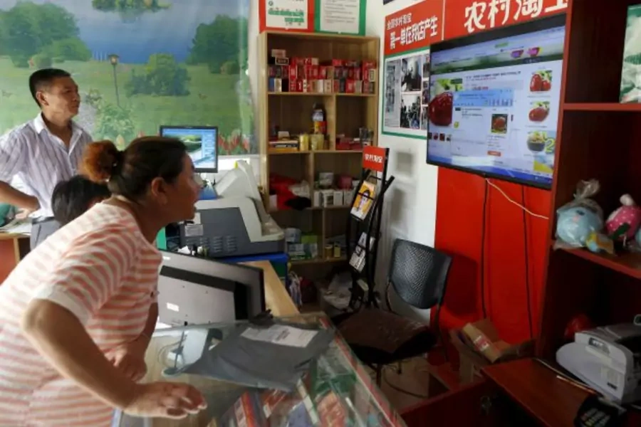 A customer shops at an Alibaba rural service center in Zhejiang province, China, July 20, 2015. While Chinese e-commerce compa...g at 460 billion yuan ($74 billion) by next year, new regulations on Internet payment tools may limit that. (Reuters/Aly Song)