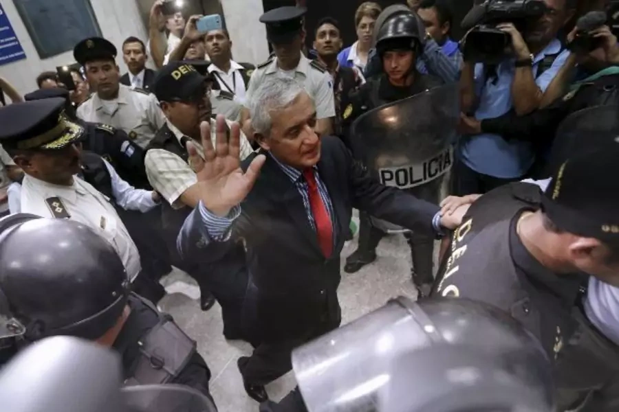 Guatemala's former President Otto Perez Molina gestures while being escorted by police officers after a hearing at the Supreme...uit overnight. Vice President Alejandro Maldonado will fill out the remaining months of Perez' term (Jorge Dan Lopez/Reuters).
