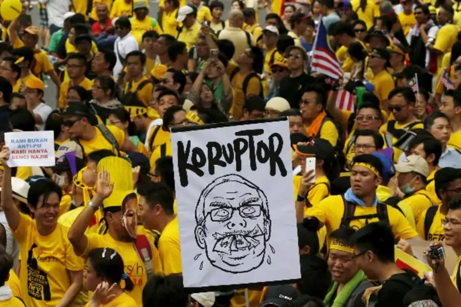 Protesters march at a rally organised by pro-democracy group "Bersih" (Clean) in Malaysia's capital city of Kuala Lumpur, Augu... his name. The placards read, "Corruptor" and "We are not against prime minister, we just hate Najib" (Olivia Harris/Reuters).