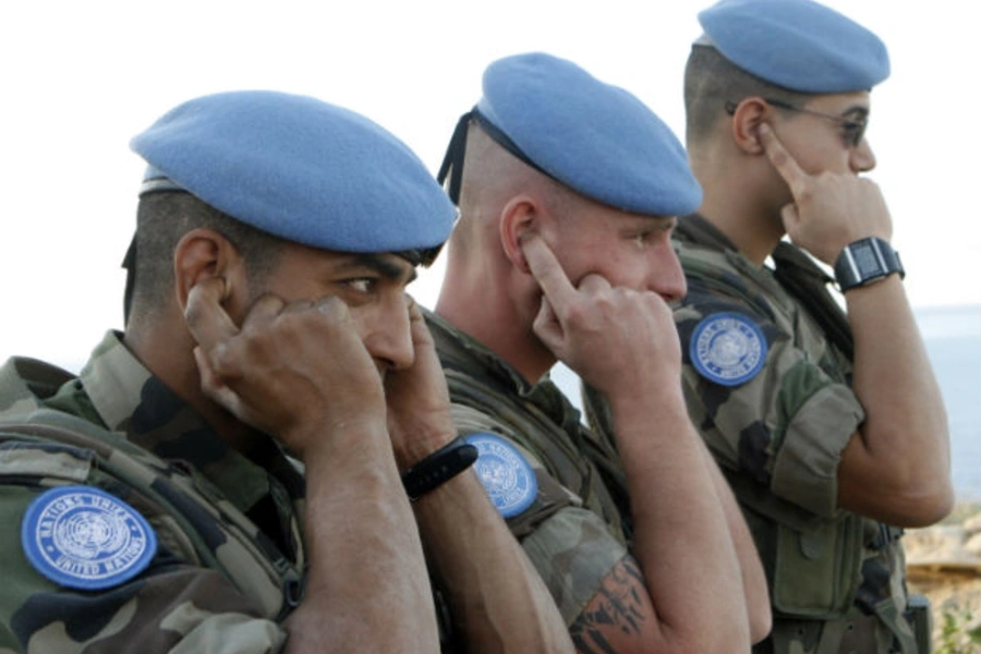 French UN peacekeepers cover their ears during a live training exercise between the Lebanese army and UN peacekeepers in southern Lebanon in December 2008.