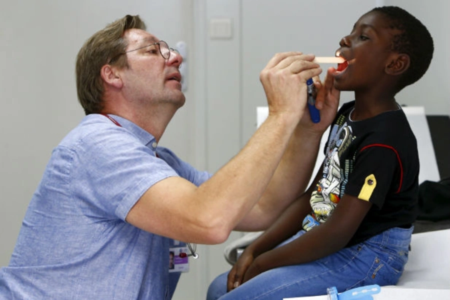 A six-year-old migrant from the Congo receives a medical check-up from a doctor at a refugee camp in Munich, Germany, on October 6, 2015.