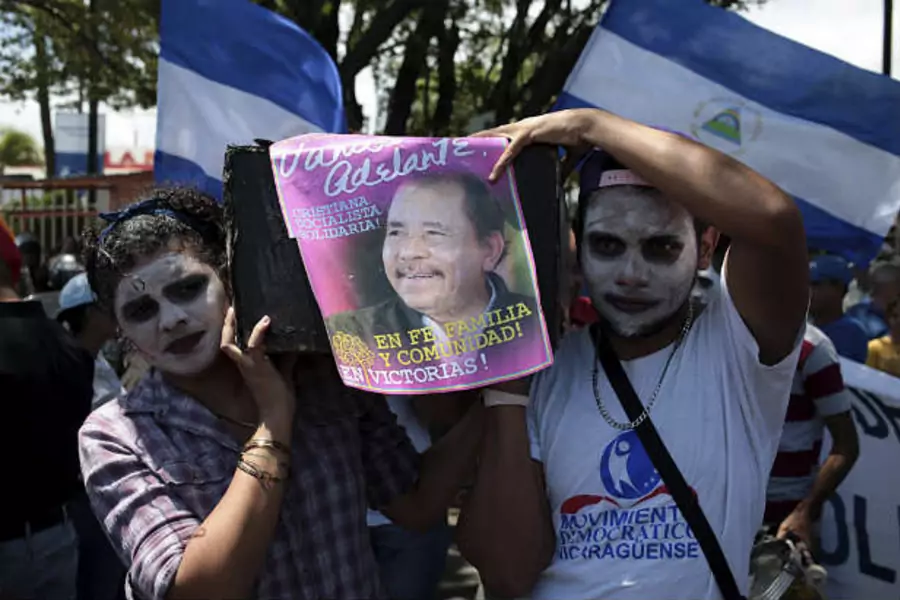 Opposition supporter holds a poster of Nicaragua's President Daniel Ortega during a protest demanding fairer presidential elections next year, in Managua, Nicaragua. (Oswaldo Rivas/Courtesy Reuters)