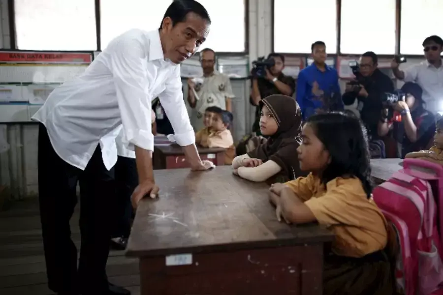 Indonesian President Joko Widodo visits an elementary school in Palangkaraya, Central Kalimantan October 31, 2015. President W...ity and quelled many of the raging forest fires, according to the national disaster agency on Friday. REUTERS/Darren Whiteside