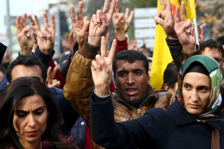 Kurdish demonstrators gesture during a protest against the curfew in Sur district and security operations, in the southeastern city of Diyarbakir, Turkey (Sertac Kayar/Reuters).