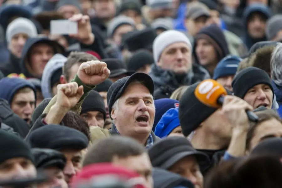 People hold a protest in front of the parliament building in Chisinau, Moldova, January 21, 2016. At least 8,000 people protes... Filip, whose hasty swearing-in ceremony at midnight also prompted a government spokesman to resign (Reuters/Viktor Dimitrov).