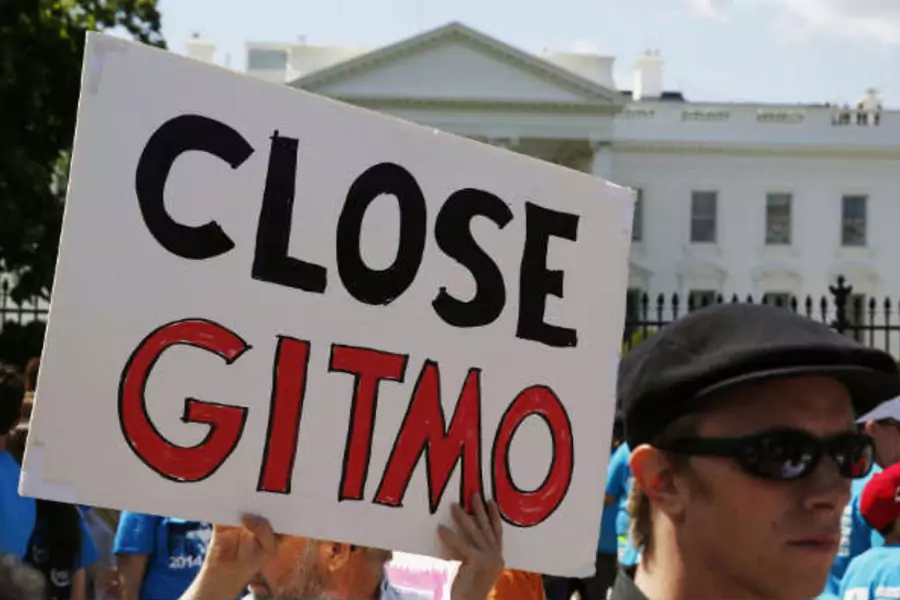 An activist holds a sign at a rally calling for the closure of the Guantanamo Bay prison in Cuba, May 23, 2014. (Larry Downing/Reuters)