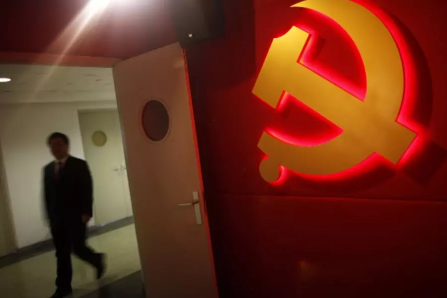 A trainee walks past a communist party logo as he attends a training course at the communist party school called China Executi...ios on everything from disease outbreaks to train wrecks. REUTERS/Carlos Barria (CHINA - Tags: POLITICS SOCIETY BUSINESS LOGO)