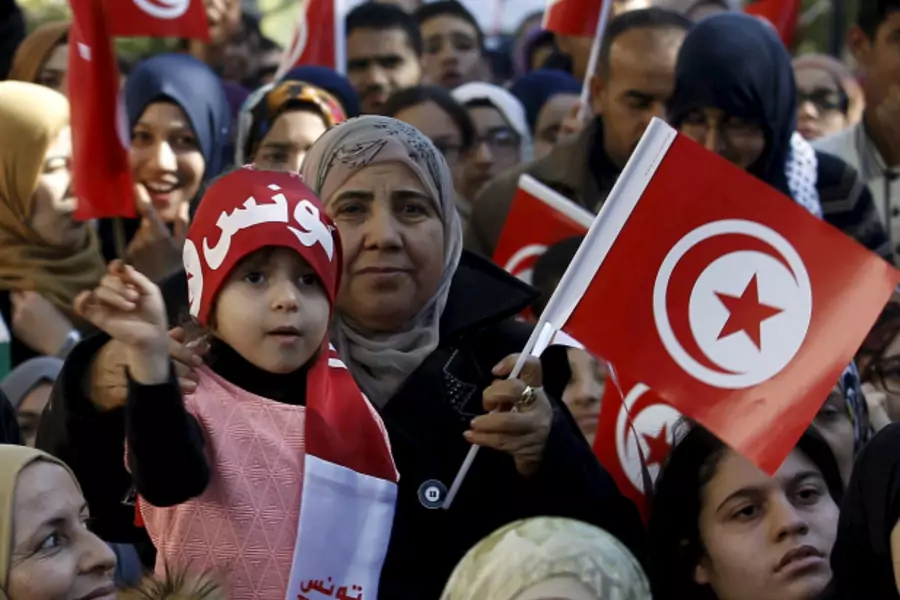 A girl waves a Tunisian flags during celebrations marking the fifth anniversary of Tunisia's 2011 revolution, in Habib Bourguiba Avenue in Tunis, Tunisia (Zoubeir Souissi/Reuters).