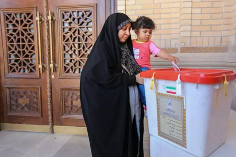 WOman iran child votes election ballot rouhani