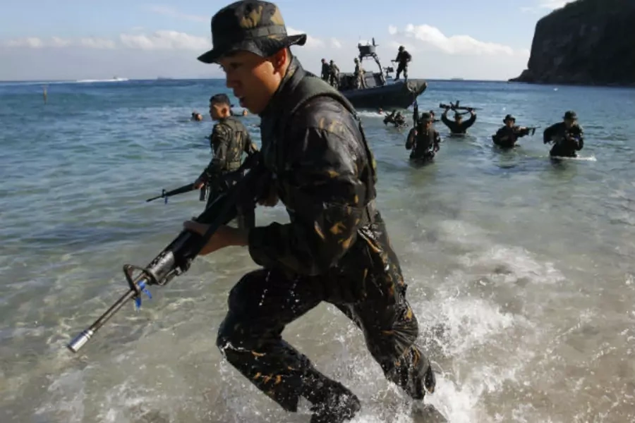 Philippine Military Academy cadets leave their boat and go ashore during a joint field training exercise at a training center south of Manila, the Philippines, on May 29, 2013.