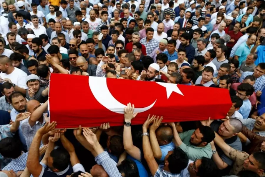 Friends and relatives of Habibullah Sefer, who was killed in Tuesday's attack at Istanbul airport, carry his flag-draped coffin during his funeral ceremony in Istanbul, Turkey (Osman Orsal/Reuters).