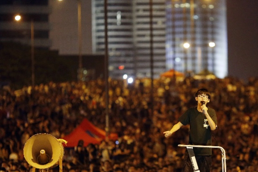 Joshua Wong, leader of the student movement, delivers a speech as protesters block the main street to the financial Central di...s, and students threatened to ramp up demonstrations if the city's pro-Beijing leader did not step down. REUTERS/Carlos Barria