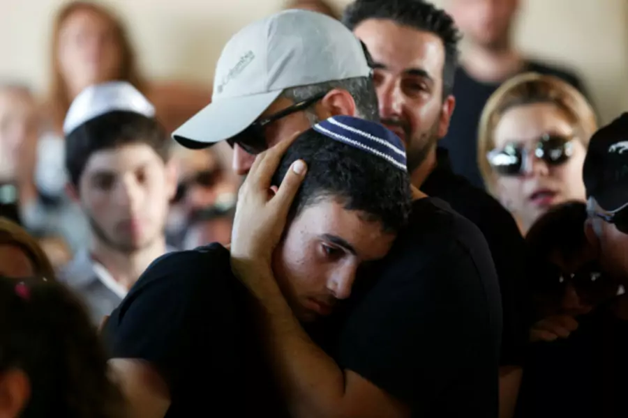 Relatives and friends mourn during the funeral of Ido Ben Ari, one of four Israelis who was killed in an Palestinian shooting attack in Tel Aviv, at a cemetery in Yavne, Israel (Ronen Zvulun/Reuters).