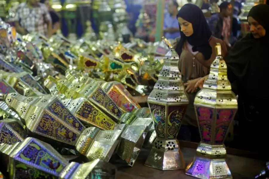 A woman with her daughter look at a stall selling festival lights and Ramadan lanterns, or "fanoos Ramadan", at Sayida Zienab district market during the first day of Ramadan in old Cairo, Egypt (Amr Abdallah Dalsh/Reuters).