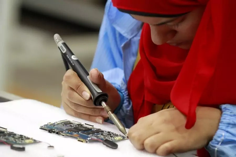 A worker is seen during manufacturing process for Egypt's first tablet computer "Inar" at a factory in Benha