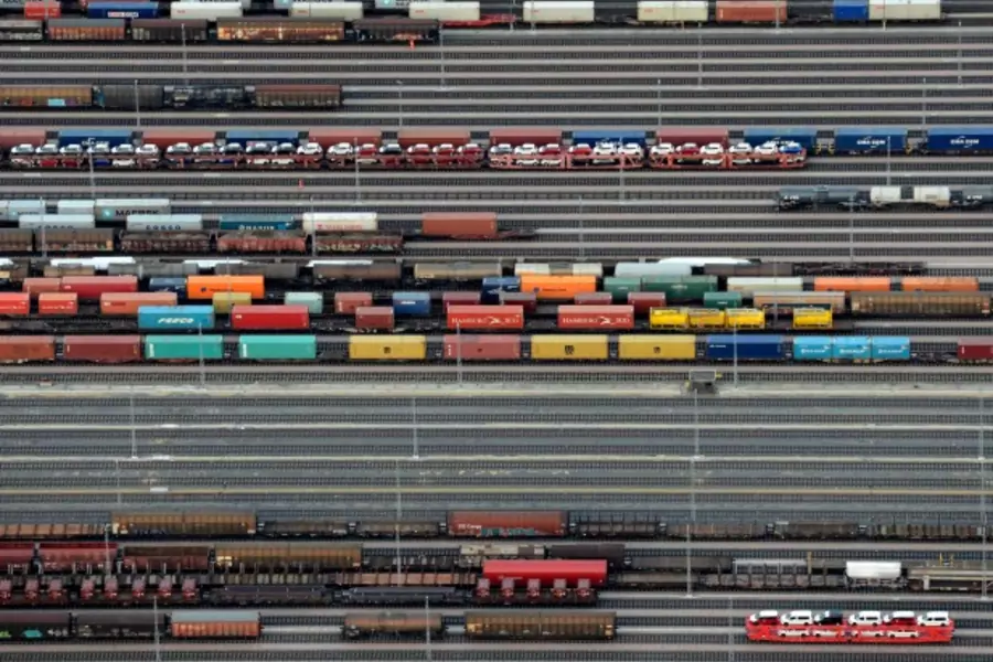 Containers and cars are loaded on freight trains at the railroad shunting yard in Maschen near Hamburg September 23, 2012 (REUTERS/Fabian Bimmer).