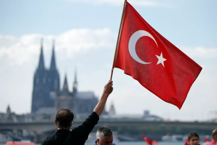 A supporter of Turkish President Tayyip Erdogan waves a Turkish flag during a pro-government protest in Cologne, Germany (Vincent Kessler/Reuters).
