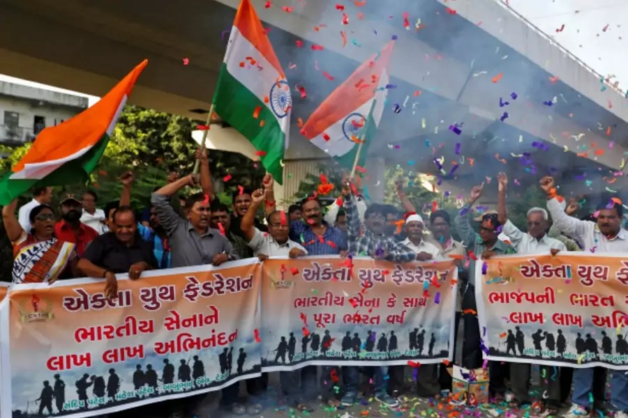 People wave national flags to celebrate after India said it had conducted targeted strikes across the de facto frontier, in Ahmedabad, India, September 29, 2016.
