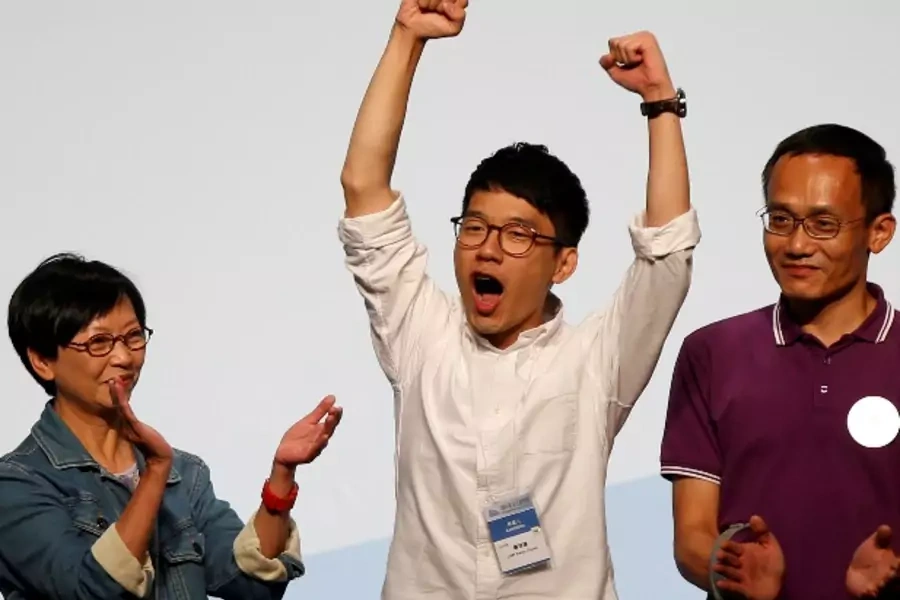 Student leader Nathan Law (C) celebrates on the podium after his win in the Legislative Council election in Hong Kong, China September 5, 2016. REUTERS/Bobby Yip